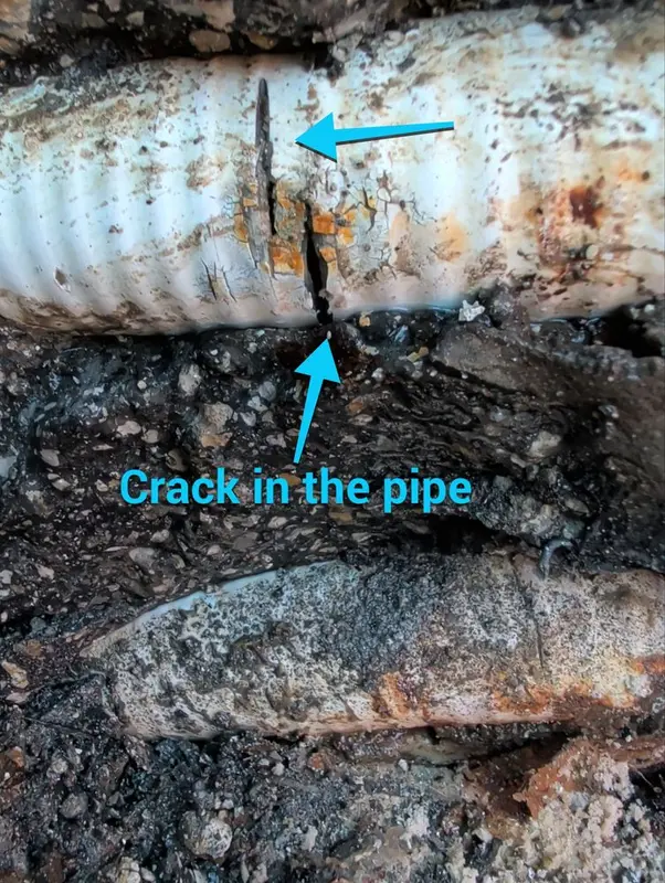 Cracked spa air line exposed under a paver deck