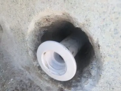 New white return fitting set in the pool wall