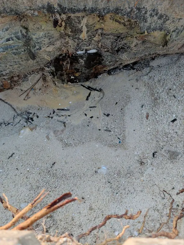 Dug out area next to a spa exposing the plumbing