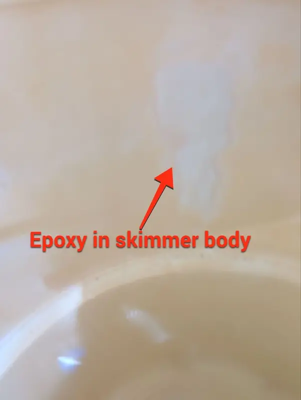 Inside of a pool skimmer with an arrow pointing to epoxy