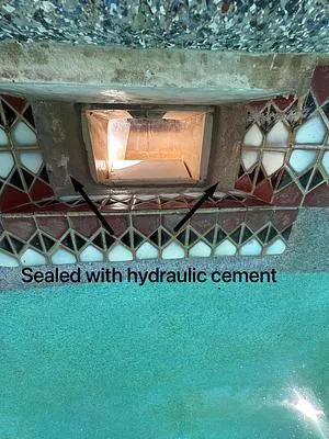 Skimmer throat sealed with hydraulic cement