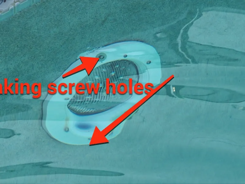 Pool light niche with arrows pointing to leaking screw holes