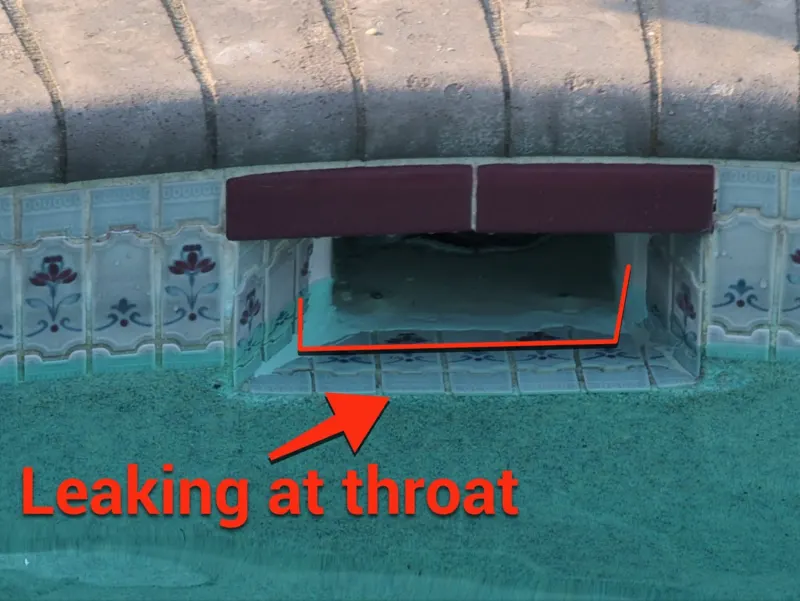 Pool skimmer opening with an arrow marking a leak at the throat