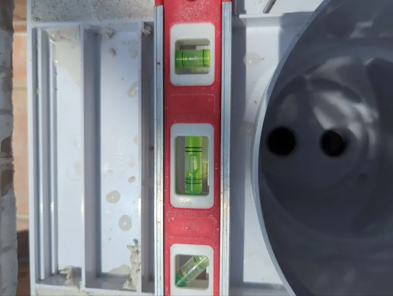 New pool skimmer being set with a level