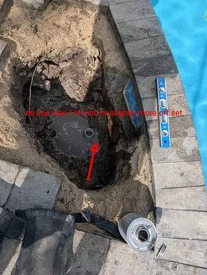 Opening in a paver deck where the old pool skimmer was removed