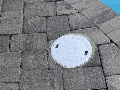 Pavers reset around a new skimmer lid