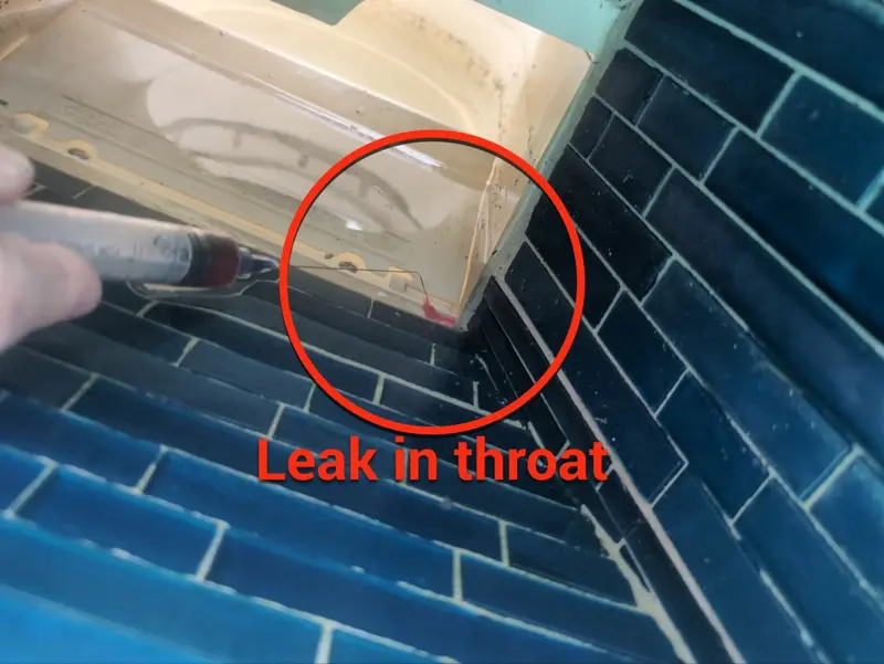 Skimmer throat with a red circle around the leak