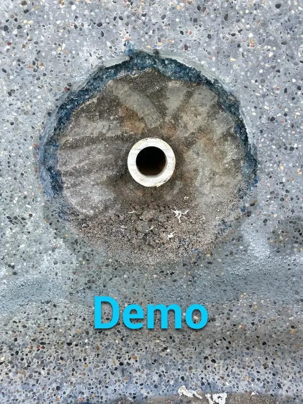Pool wall with finish removed around a return fitting