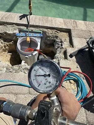 Pressure gauge during a plumbing test at the skimmer