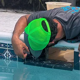 Leak tech inspecting a pool skimmer for leaks