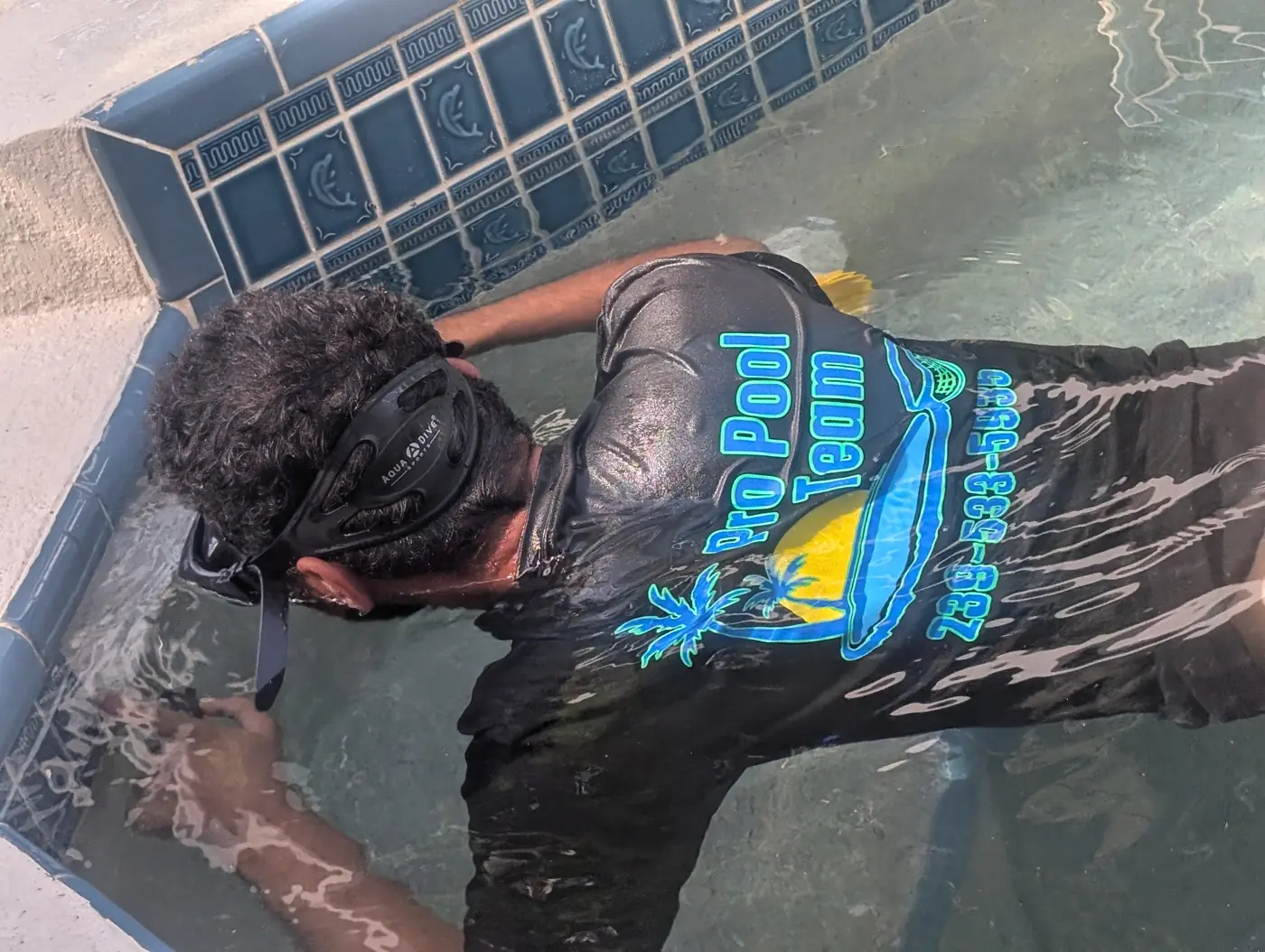 Leak tech diving a pool to inspect the main drain and fittings