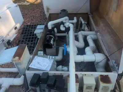 Community pool equipment pad with pumps and filters