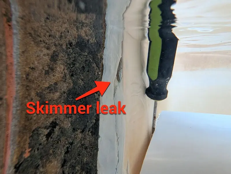 Skimmer throat with an arrow marking the leak