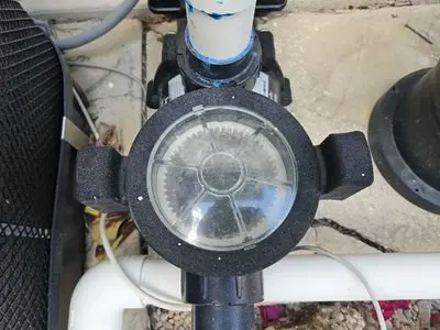 Pool pump with a clear lid on the equipment pad