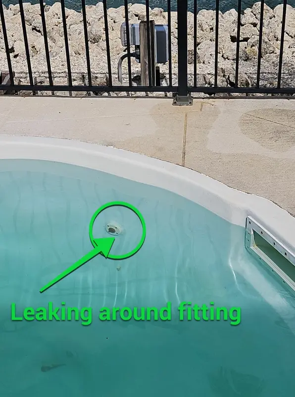 Fiberglass pool wall with a circle around a leaking return fitting