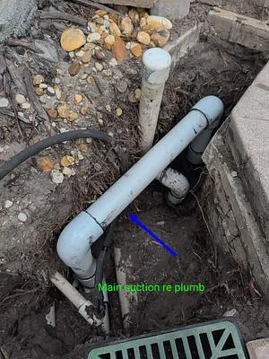 Re-plumbed main suction line in an open hole beside the pool