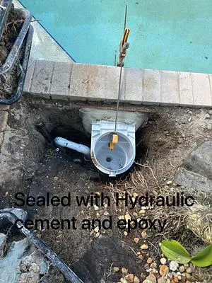 New skimmer set in the ground and sealed with hydraulic cement