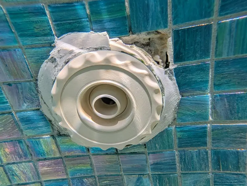 Spa jet with old epoxy around the fitting