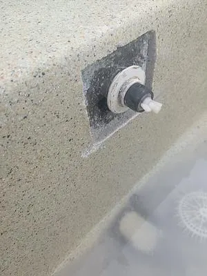 Spa jet in a spa bench with the surface cut out around it