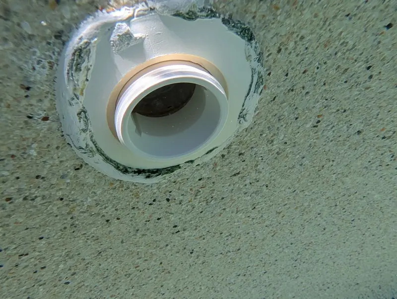 Spa return fitting with epoxy around it