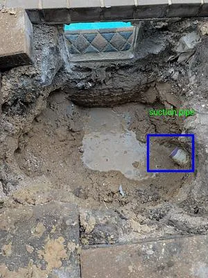 Hole in a paver pool deck where the old skimmer was removed