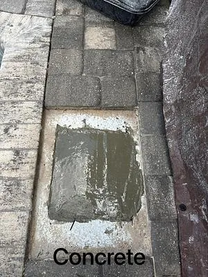 Fresh concrete poured under the paver deck