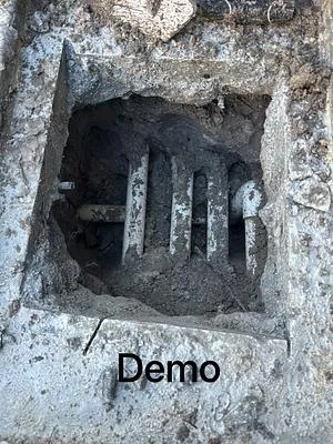 Concrete broken out over pool plumbing lines