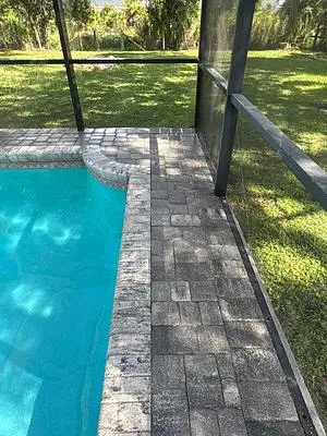 Paver deck reset beside the pool after the repair