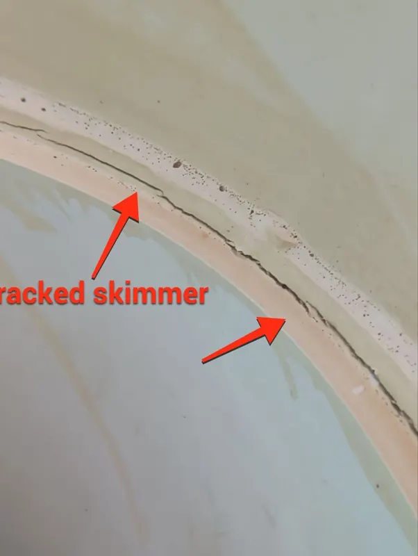 Inside of a pool skimmer with arrows pointing to a crack along the rim