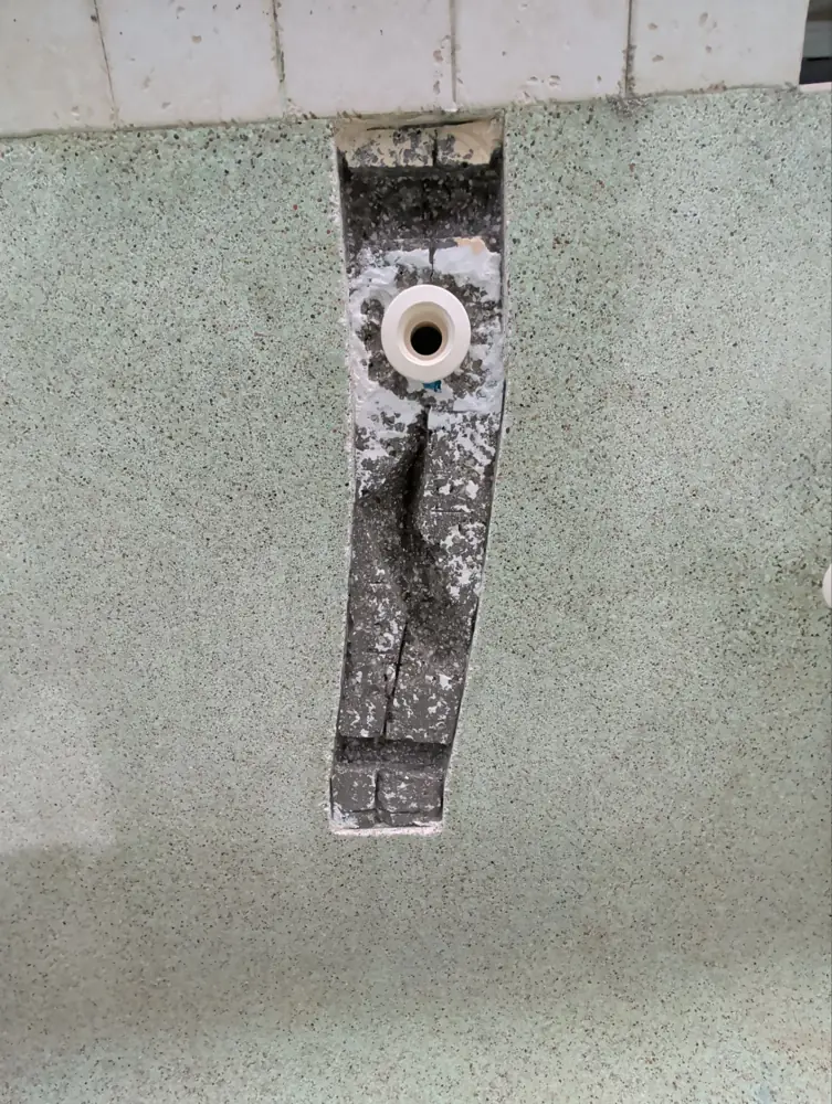 Crack in a pool wall opened up around a return fitting for repair