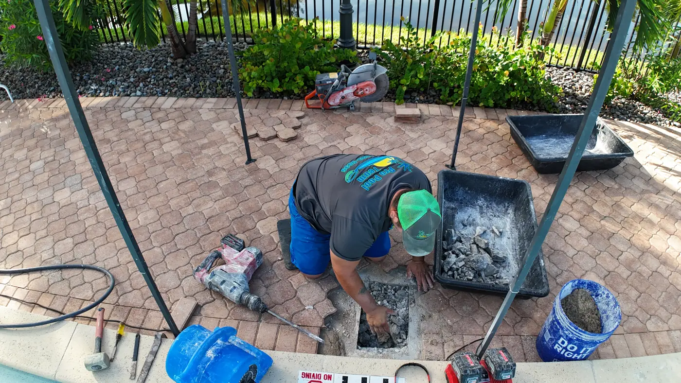 Pavers lifted to repair a broken underground pool pipe