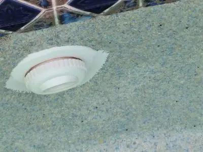 Pool return fitting with old epoxy around it