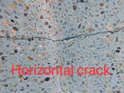 Horizontal crack in a pebble pool finish