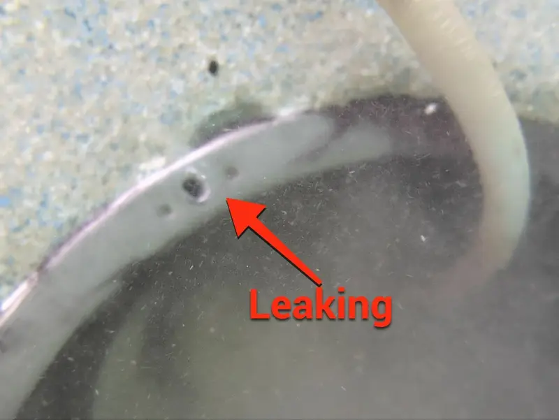 Light niche rim with an arrow pointing to a leaking screw hole