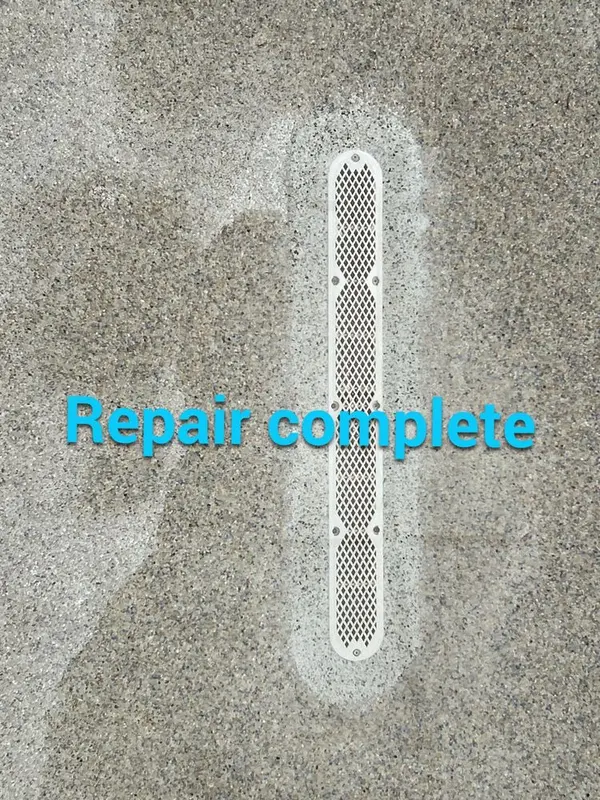 Patched pool floor around a long slot main drain