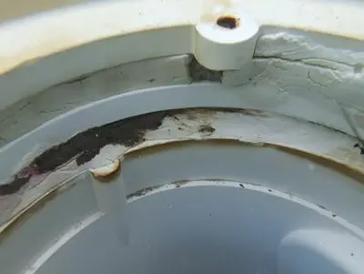 Old patch material inside a pool fitting