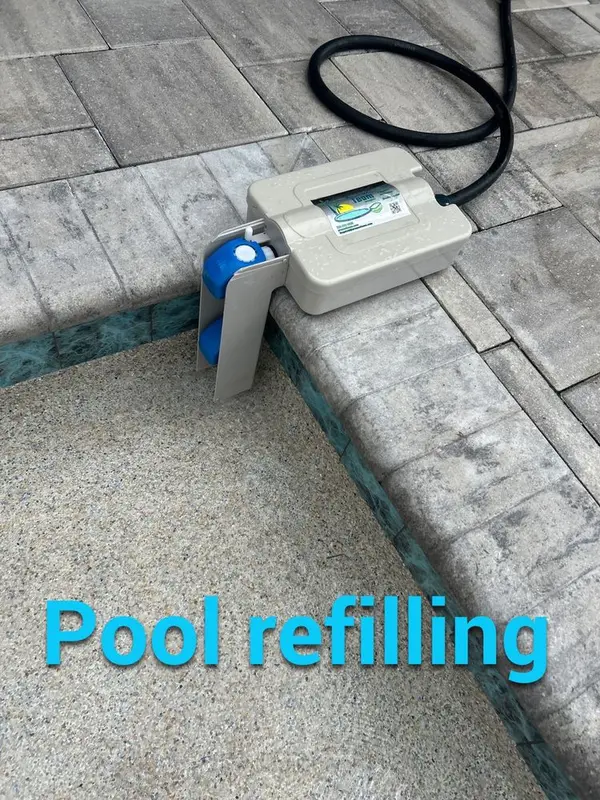 Autofill hose on the pool edge refilling the pool