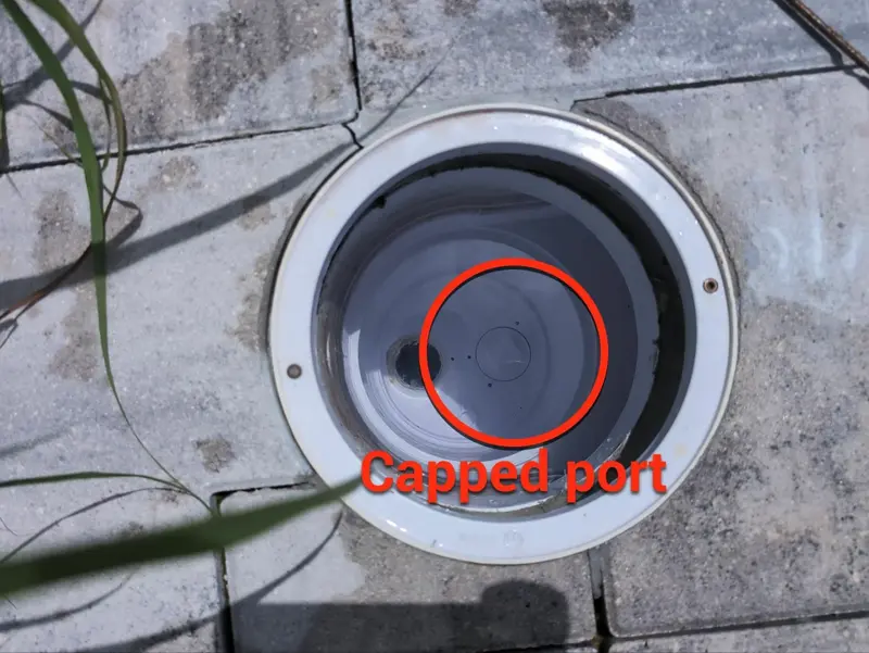 Inside a pool skimmer with the unused port capped