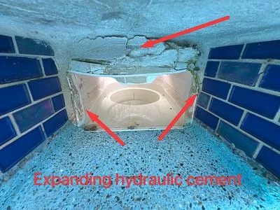 Skimmer throat with expanding hydraulic cement marked