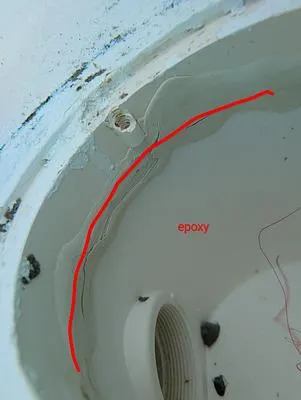 Inside a pool skimmer with a line marking old epoxy