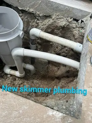 New skimmer with new white plumbing below it