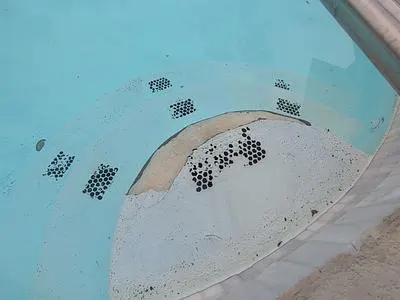 Painted pool step with the surface peeling