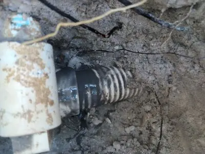 Flex pipe pulling out of a white PVC fitting