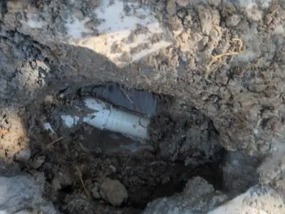 Hole dug in the deck exposing a spa plumbing line